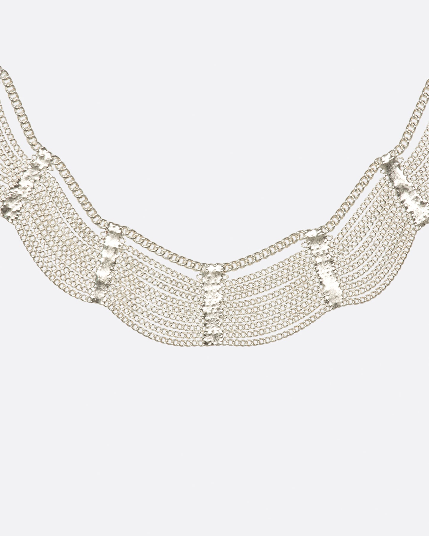 A sterling silver, fringy necklace with silver soldered sections to create a scalloped effect.