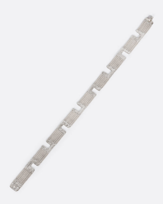 A sterling silver multi-strand chain bracelet with alternating pattern finished with silver solder.