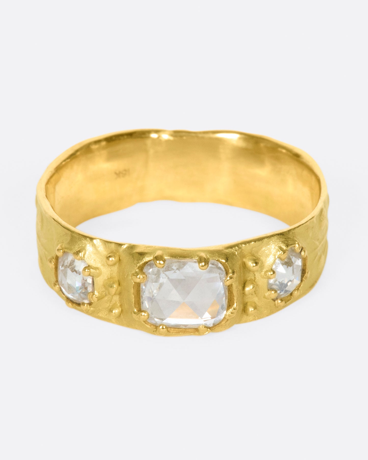 This thoughtfully detailed band has a sparkly rose-cut oval diamond in the center and rose-cut round diamonds on either side