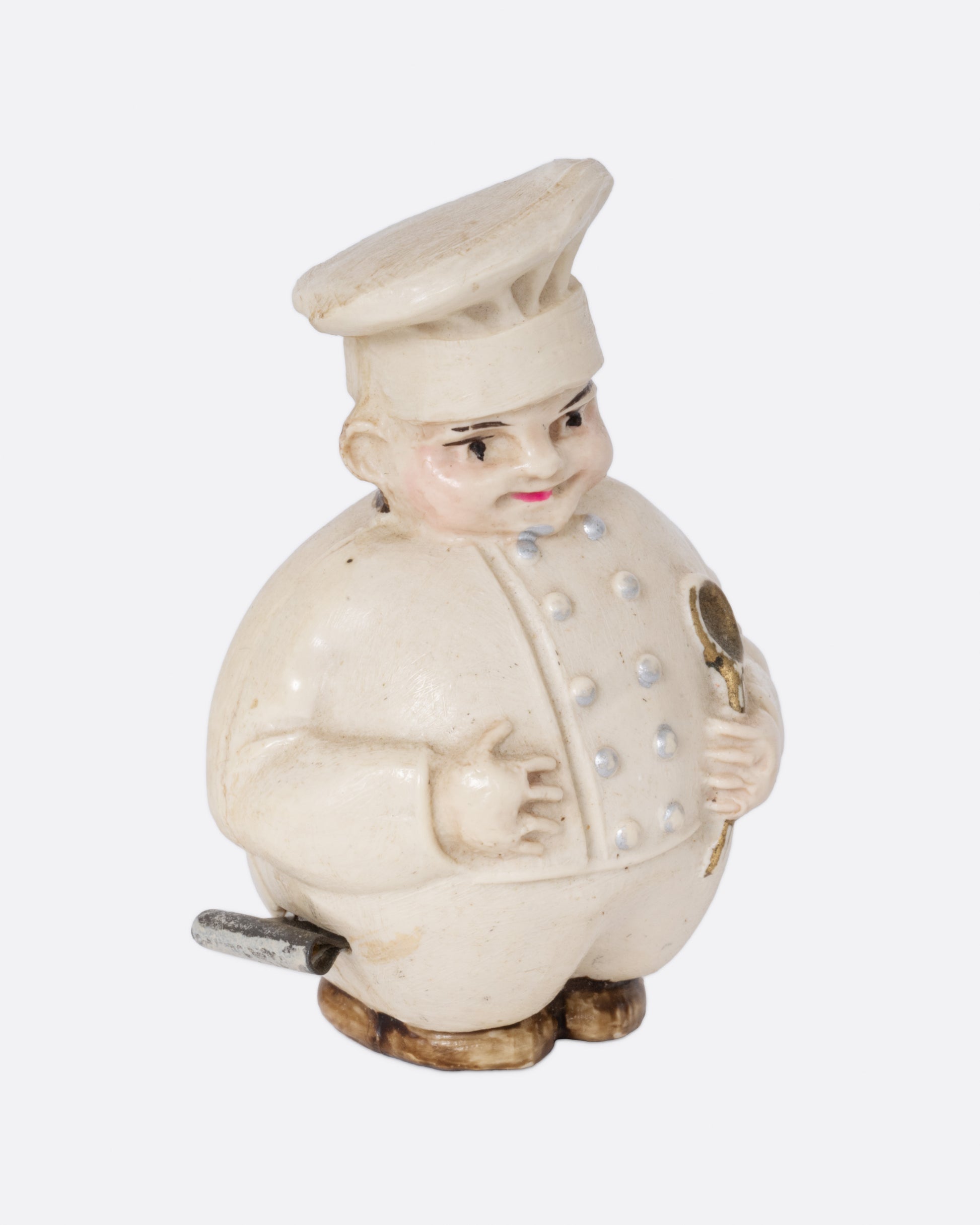 A chef shaped tape measurer, shown from the side.