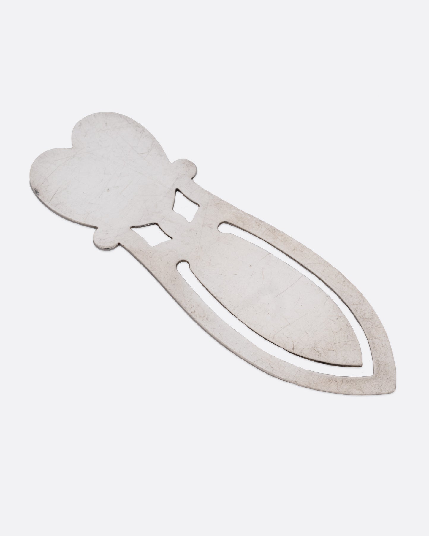 A silver heart shaped bookmark. Shown from the front, lying flat.