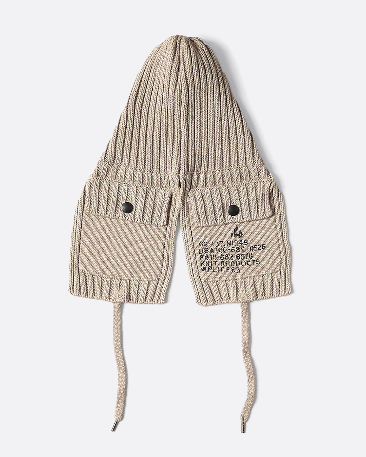 A beige knit hat with ear flaps and pockets.