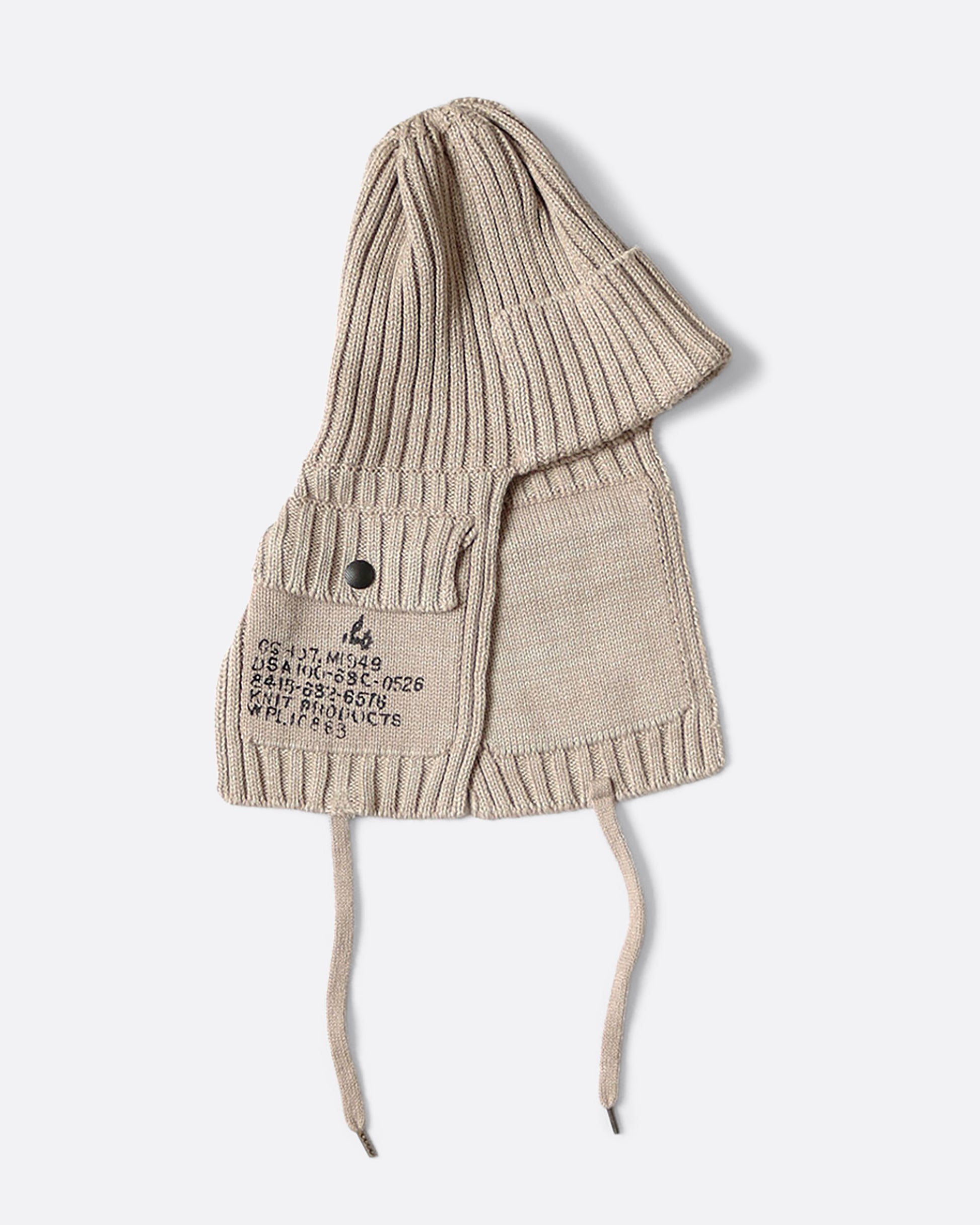 A beige knit hat with ear flaps and pockets.