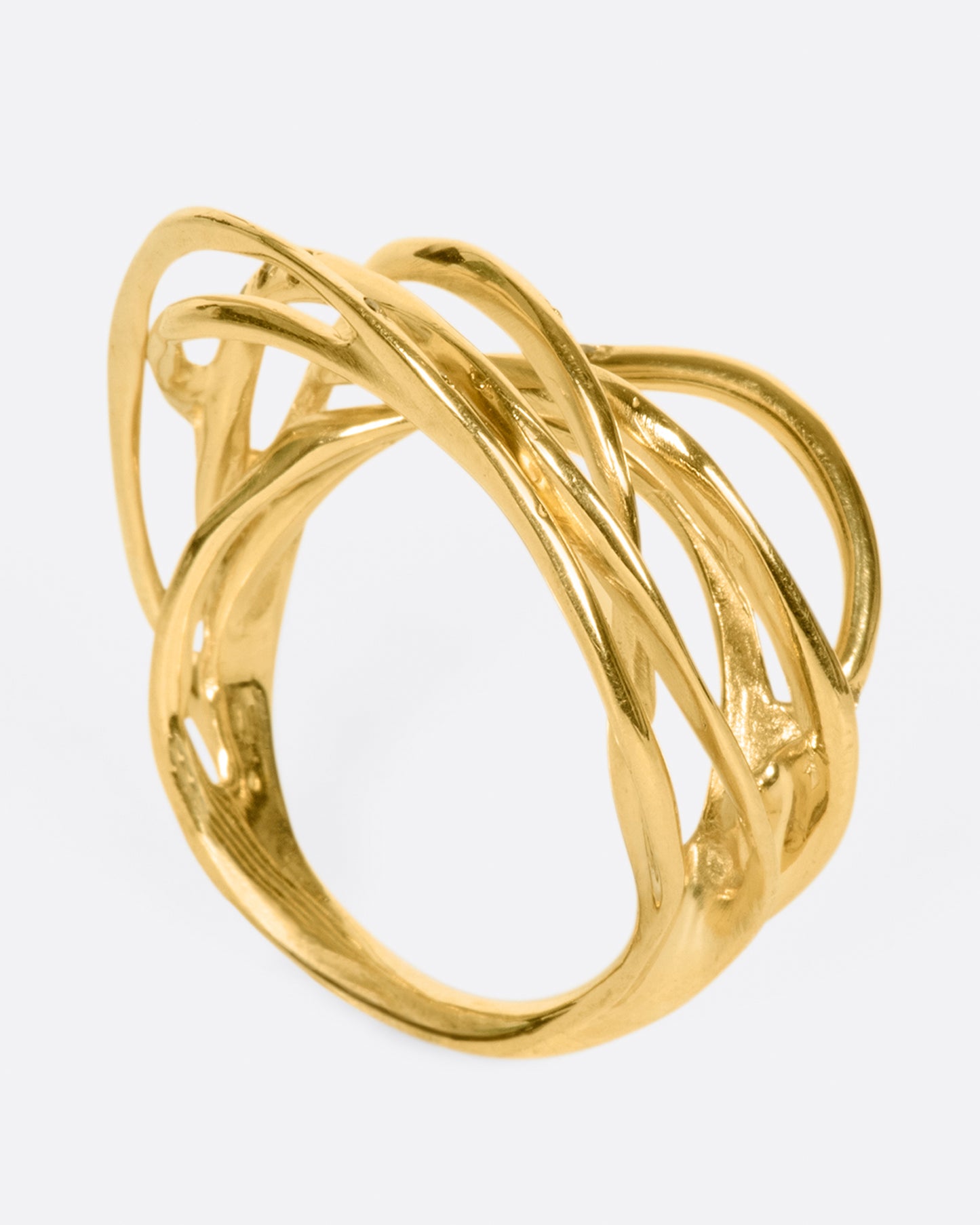 A yellow gold ring formed from multiple strands of gold, dotted with cognac diamonds. Shown from the side.