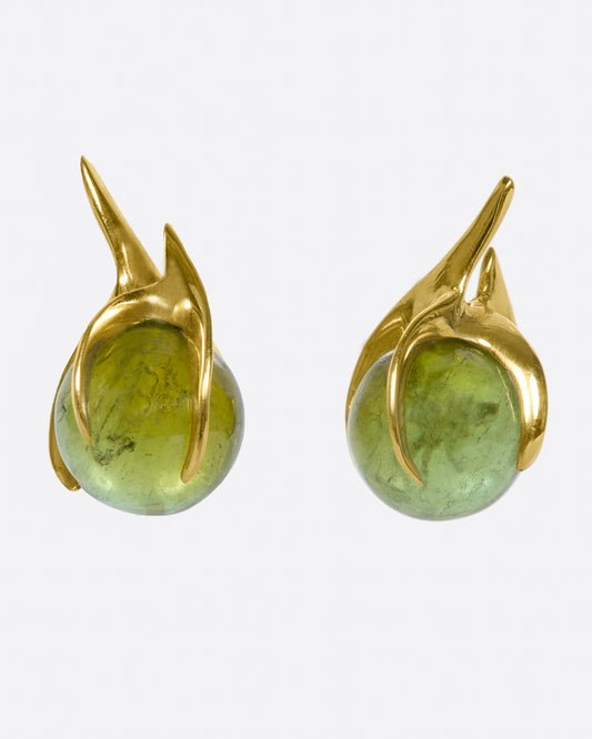 A pair of yellow gold stud earrings with green tourmaline spheres set in flame-like settings.