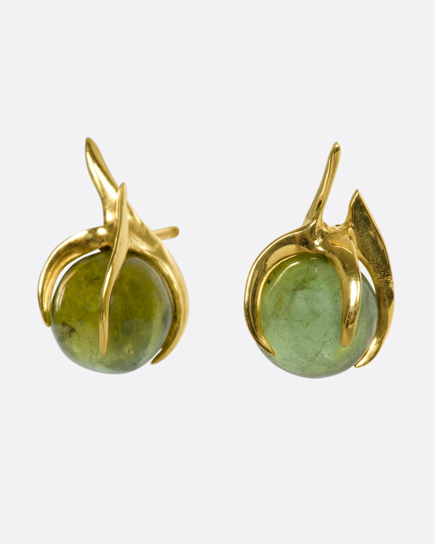 A pair of yellow gold stud earrings with green tourmaline spheres set in flame-like settings.
