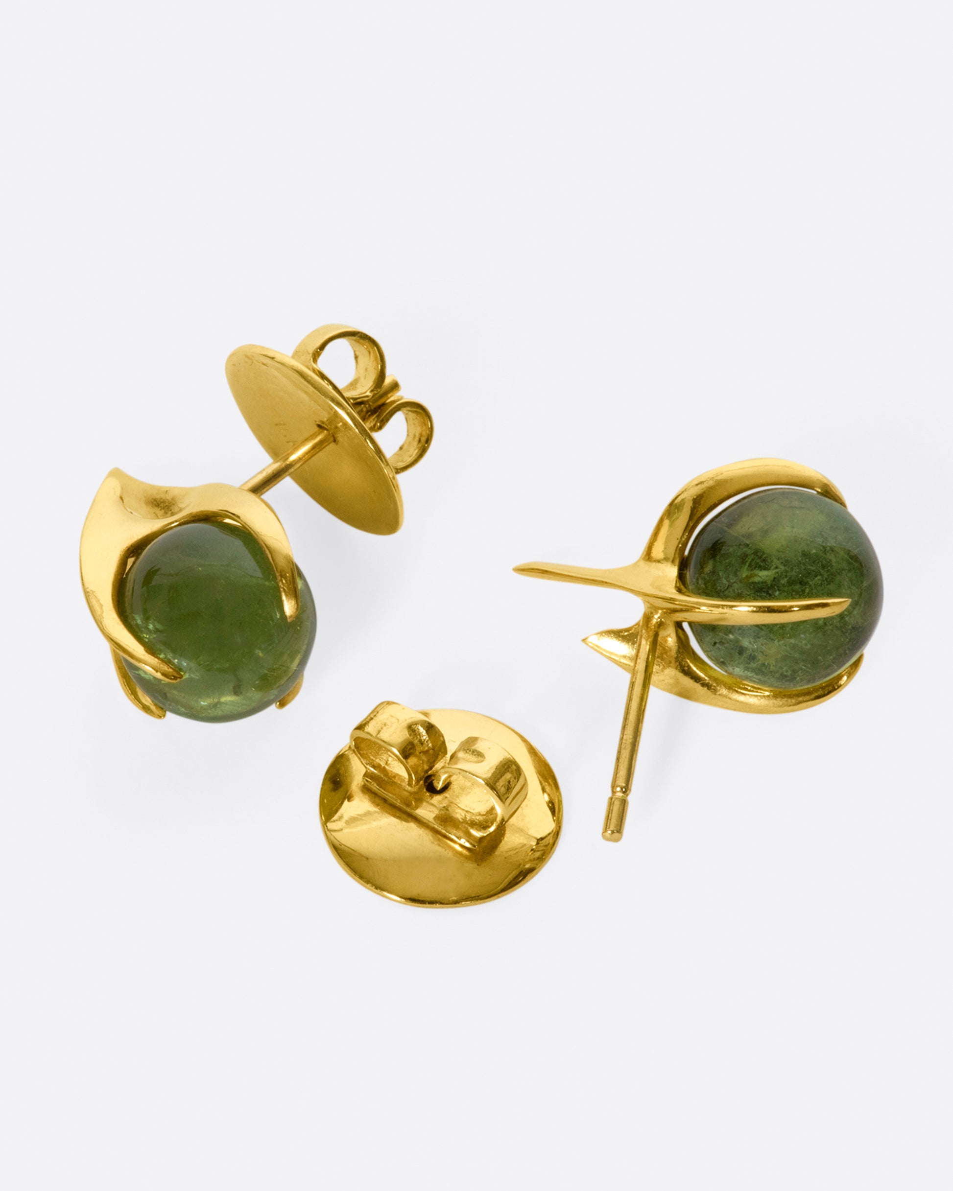 A pair of yellow gold stud earrings with green tourmaline spheres set in flame-like settings, shown from the side.