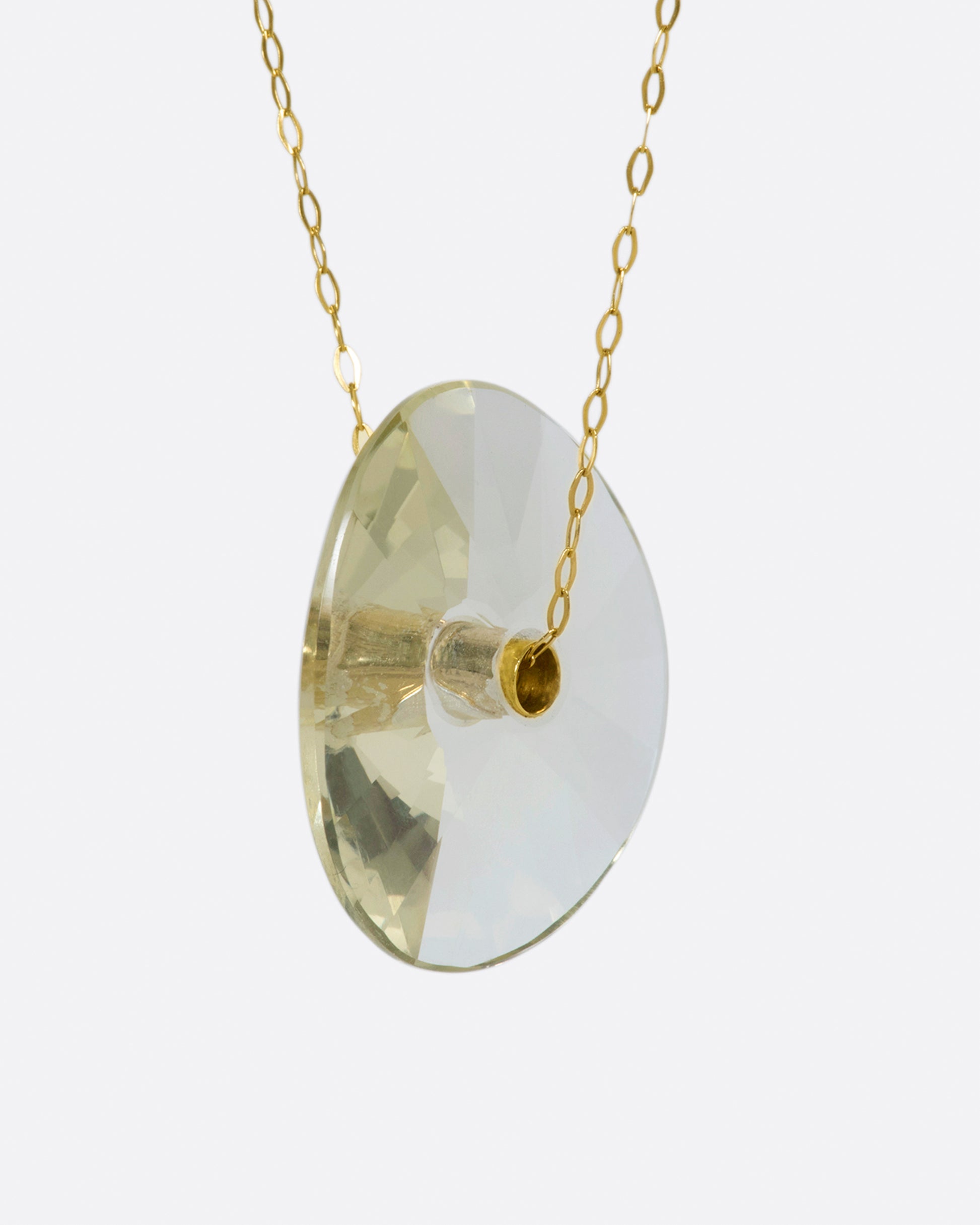 A yellow gold chain necklace with a large champagne quartz bead pendant.