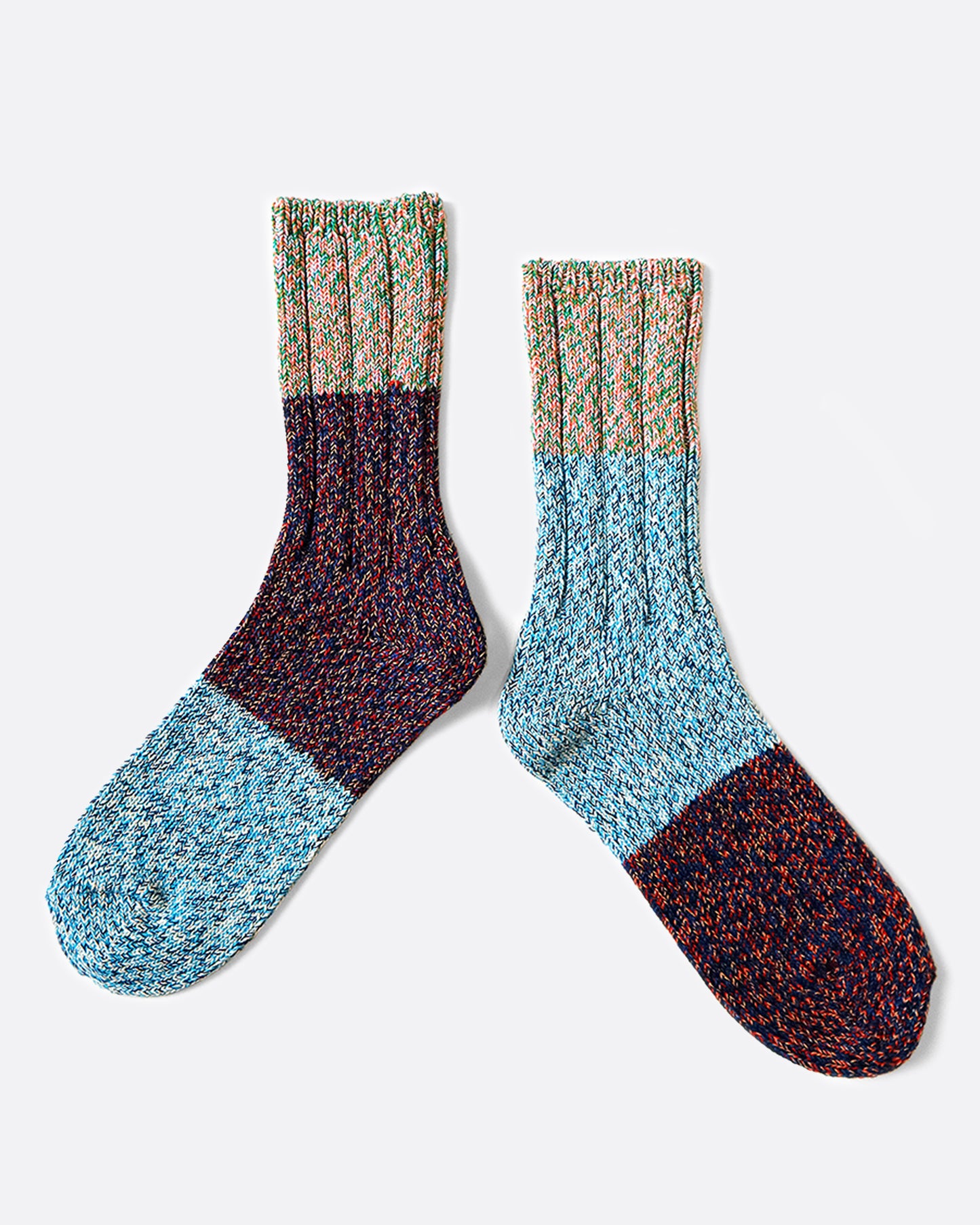 A pair of thick, loosely knit socks that are almost identical, but not quite.