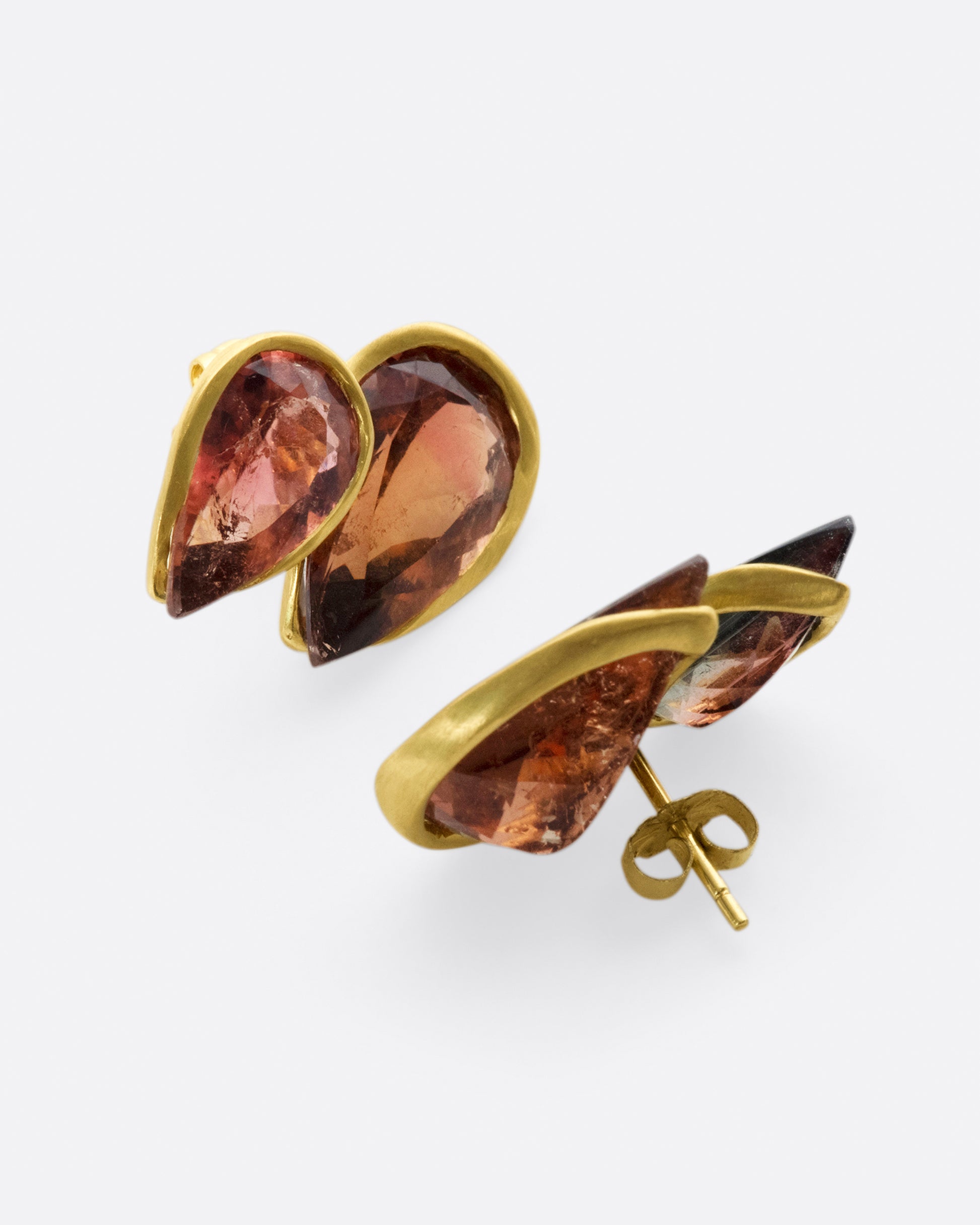 These earrings both look like flames and are the colors of dark embers, but what makes them really special is their modified bezel settings.