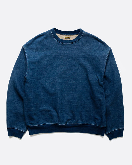 A loose fitting, indigo fleece sweatshirt with a T-shaped split back and cinch.