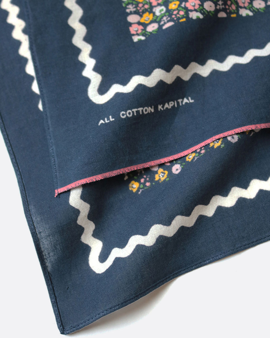 A navy bandana featuring a skull and flower motif.