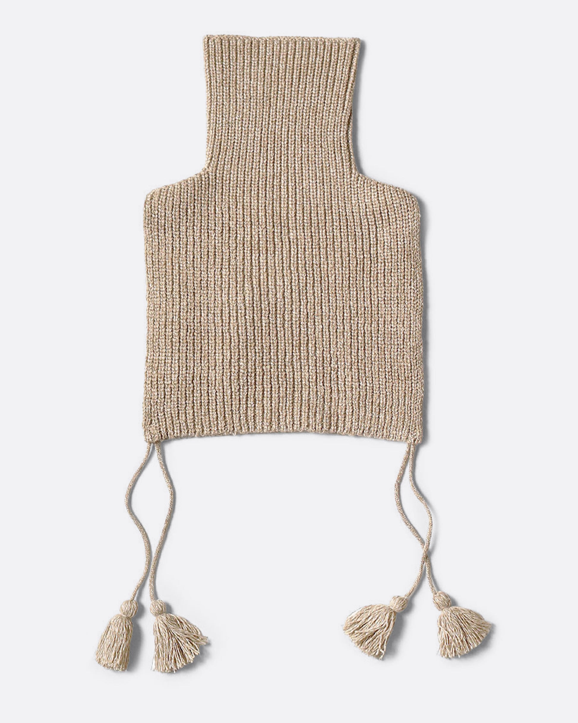 A beige loose knit bib poncho with a front pocket, long tassels, and a high neck, shown from the back. 