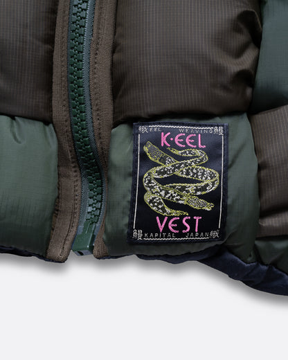 A close up of the tag on a A green nylon padded vest woven in a traditional basket weave design. It has a reversible grey interior, a front zip closure, curved hemline, and internal snap welt hand pockets. 