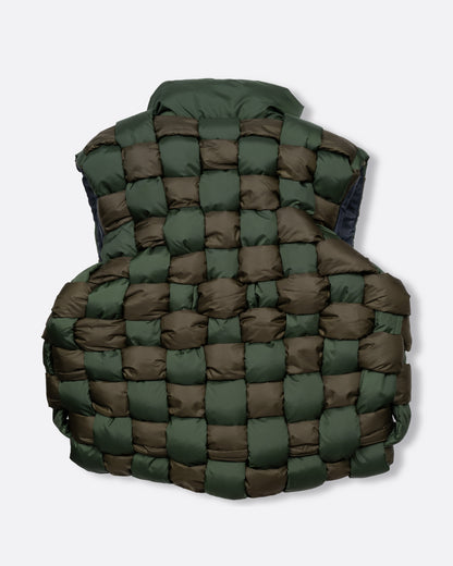 A green nylon padded vest woven in a traditional basket weave design. It has a reversible grey interior, a front zip closure, curved hemline, and internal snap welt hand pockets. Shown from the back.