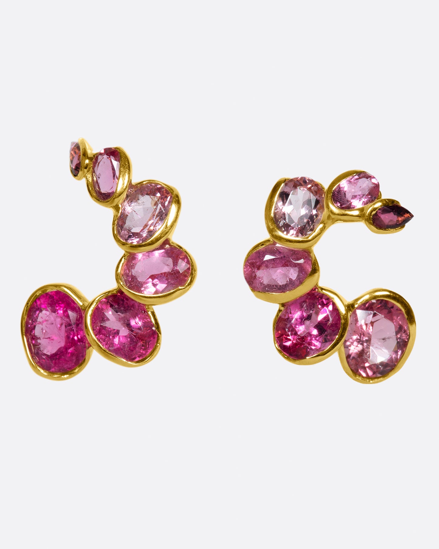 A pair of curved earrings with ombré pink tourmalines, shown from the front.