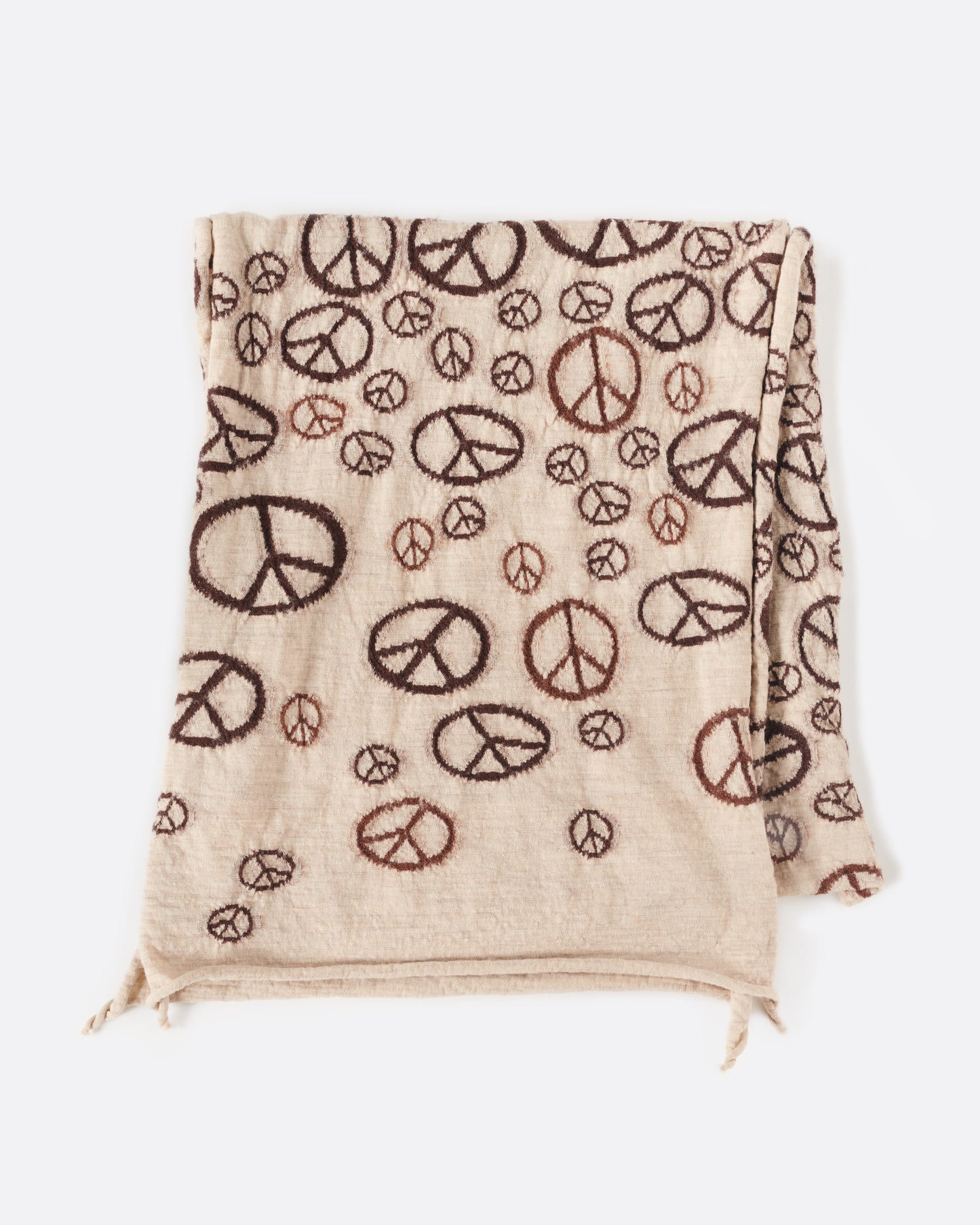 A compressed wool scarf covered in a collage of peace signs.