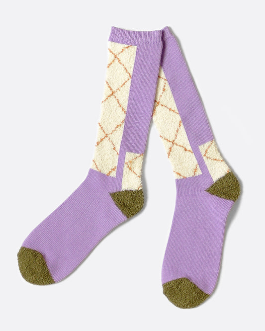 A pair of socks with a crossed patterned inspired by the stitching on double-knee work pants.