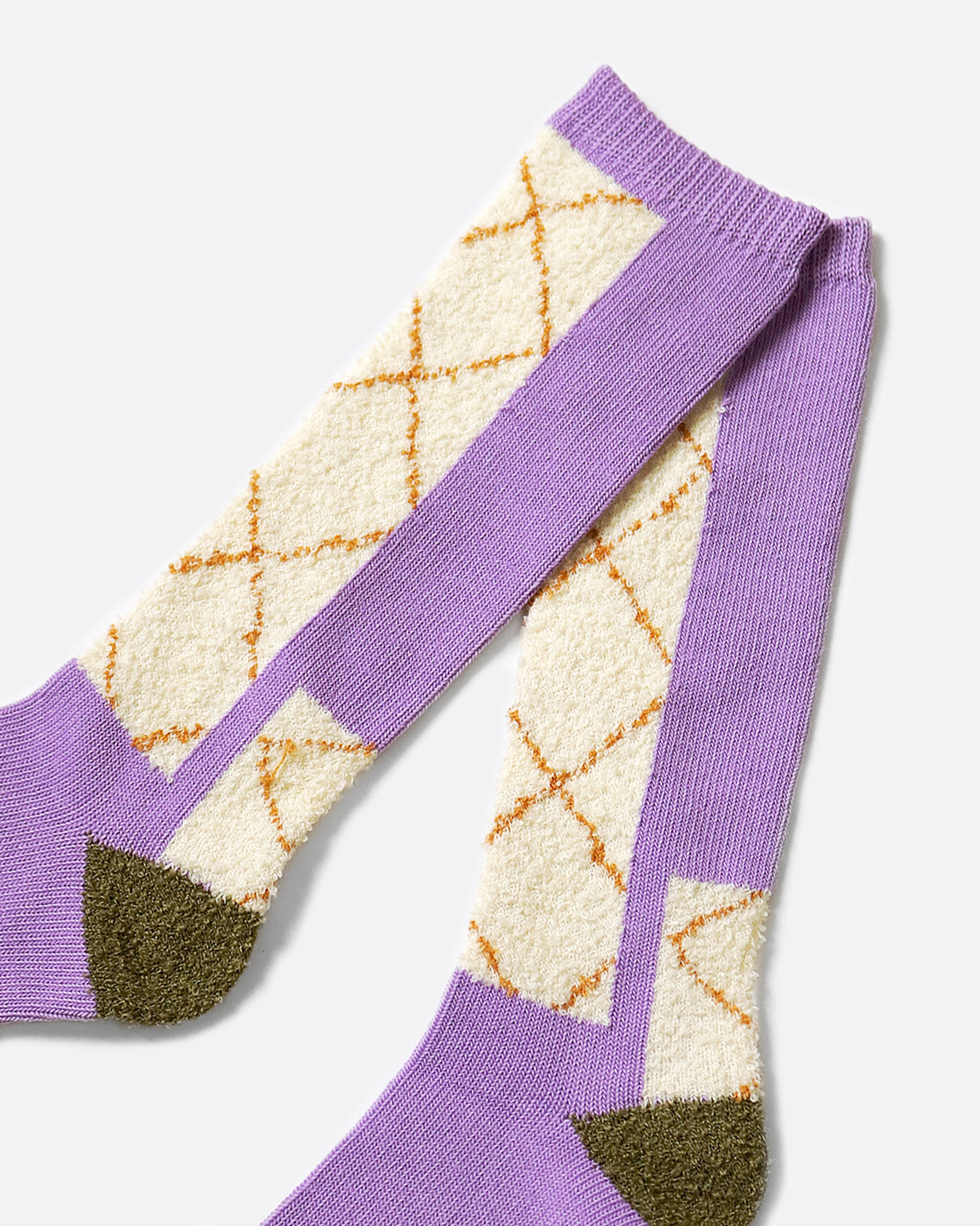 A pair of socks with a crossed patterned inspired by the stitching on double-knee work pants.