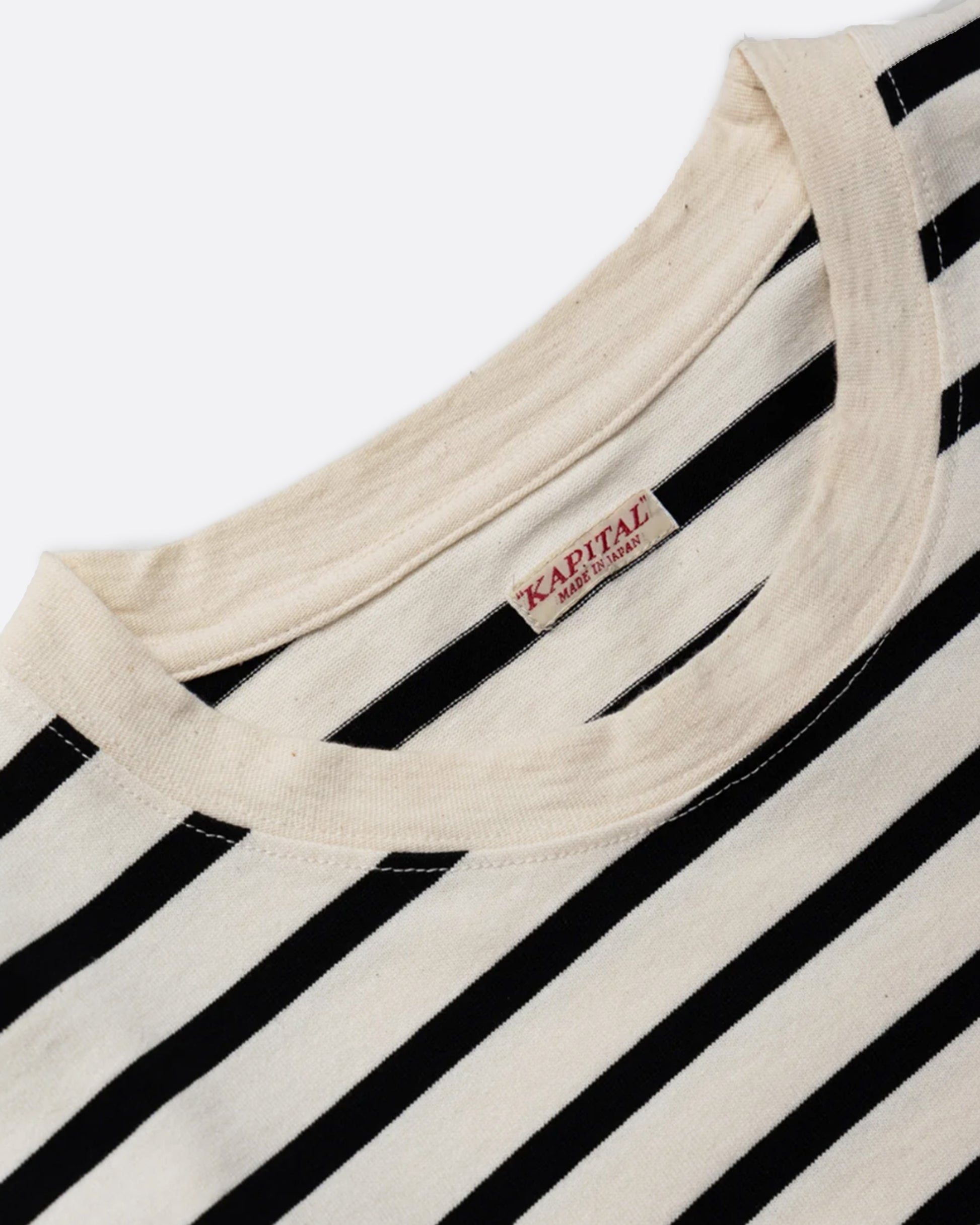 A black and cream striped, cotton, crewneck shirt with Kapital's fan favorite rainbow smiley elbow patches.