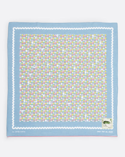 Kapital fastcolor selvedge bandana in sax blue, with a small multicolor skull and flower print and a white wavy border