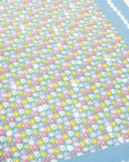 Light blue skull and flower print bandana, close view of the print
