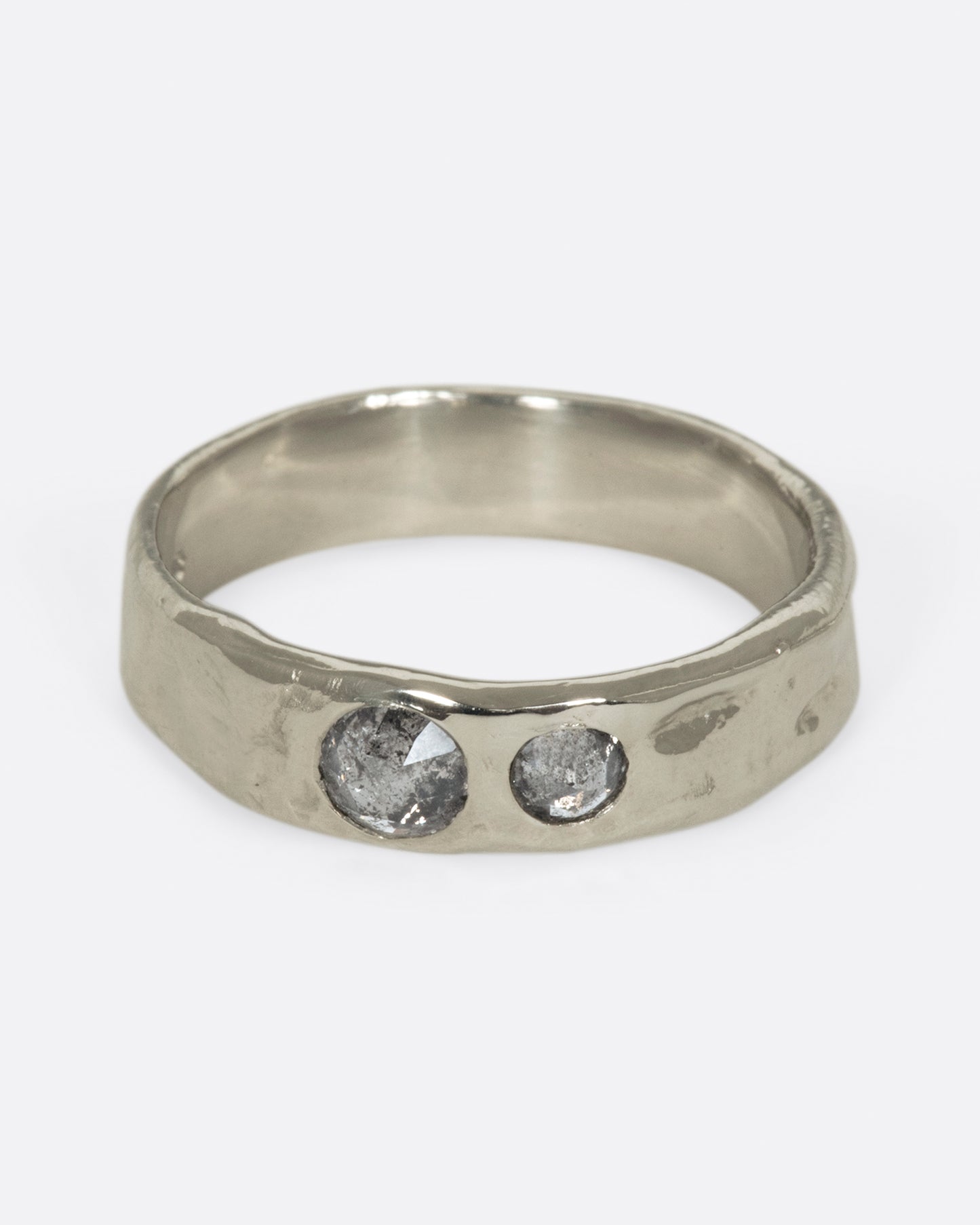 Medium wide band with light texture, featuring two rose cut salt & pepper diamonds flush to the band. 