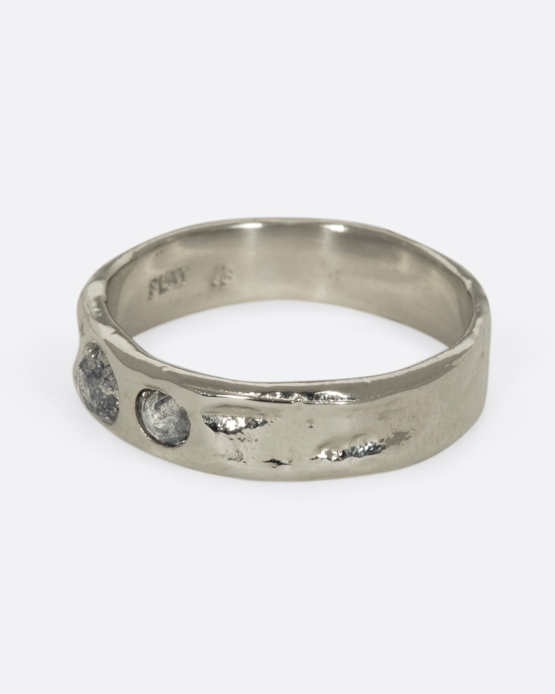 Medium wide band with light texture, featuring two rose cut salt & pepper diamonds flush to the band. 