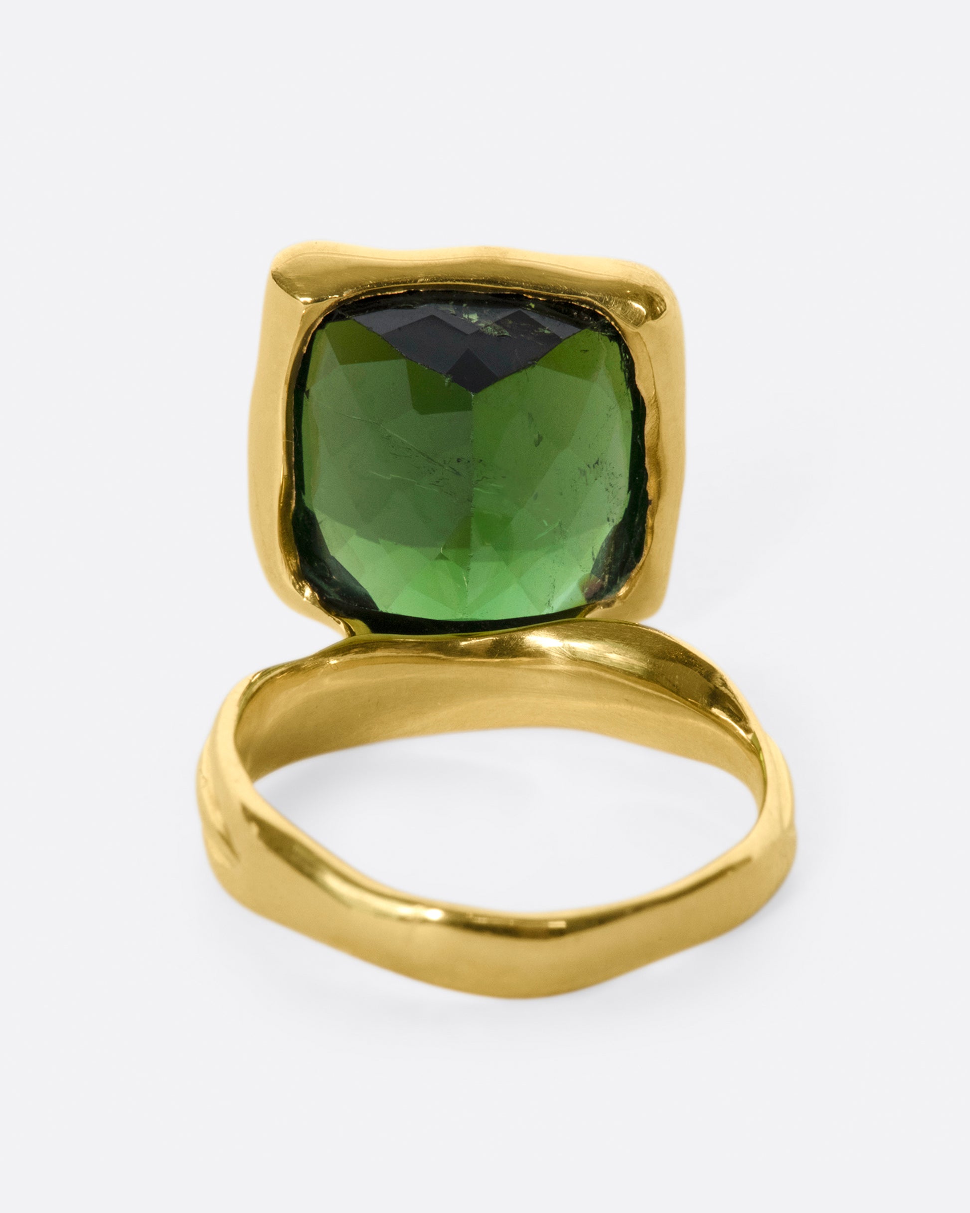 This ring is designed to showcase the tourmaline; the band is set off to one side and the setting is raised to allow for maximum light to pass through the stone.