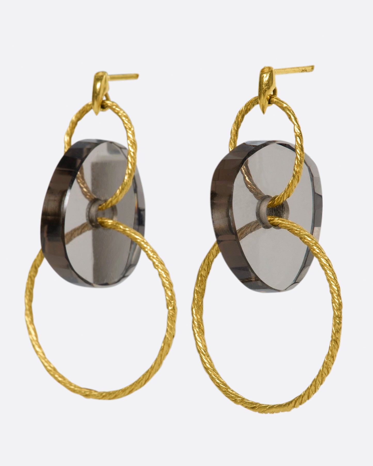 A pair of yellow gold stud earrings with two circular drops that are connected by smokey quartz beads.