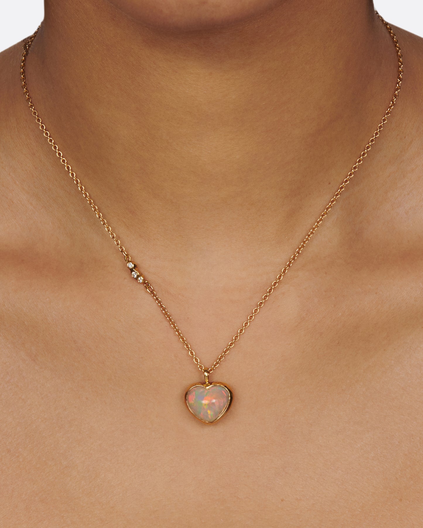 A glorious, bubble-like, Australian opal heart pendant whose fire can be seen from every angle.