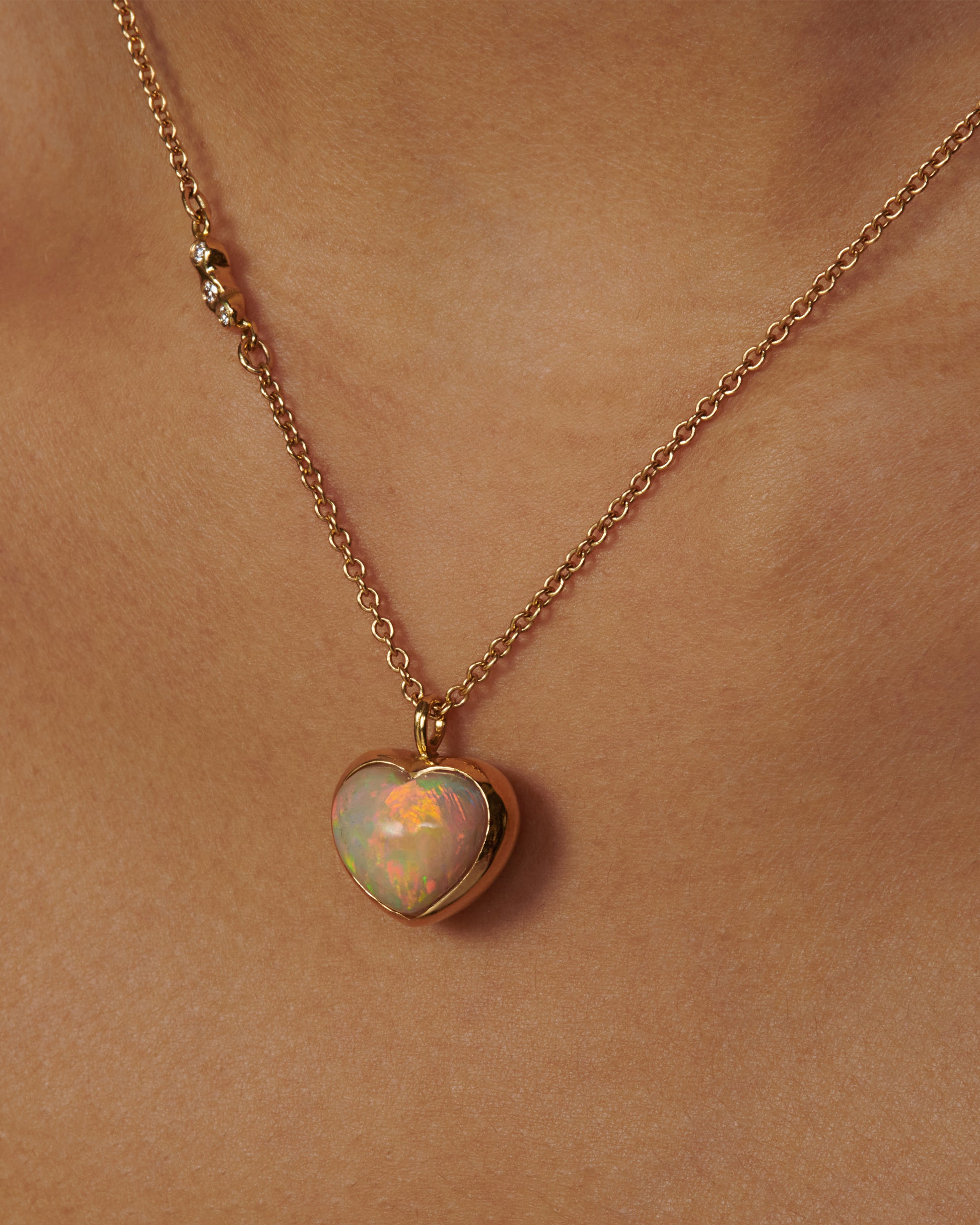 A glorious, bubble-like, Australian opal heart pendant whose fire can be seen from every angle.