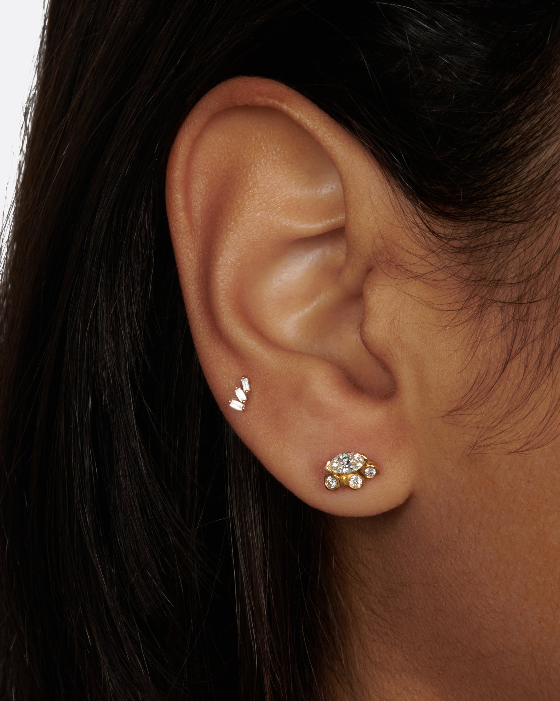 A pair of cluster studs featuring large marquise diamonds and smaller round diamonds along their edges.