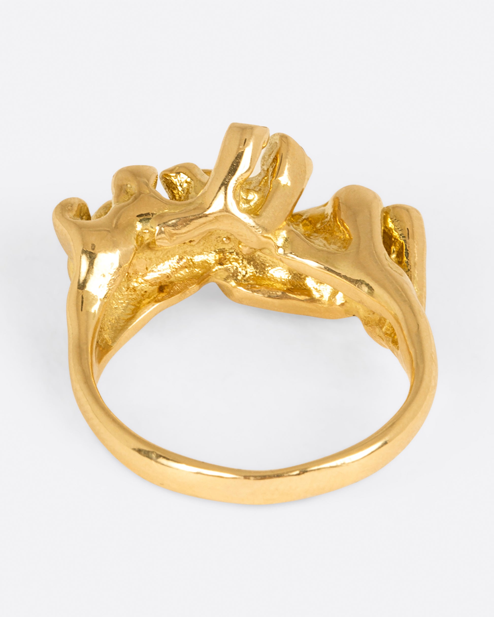 A yellow gold ring with sea anemone tentacles, dotted with diamonds, shown from back.