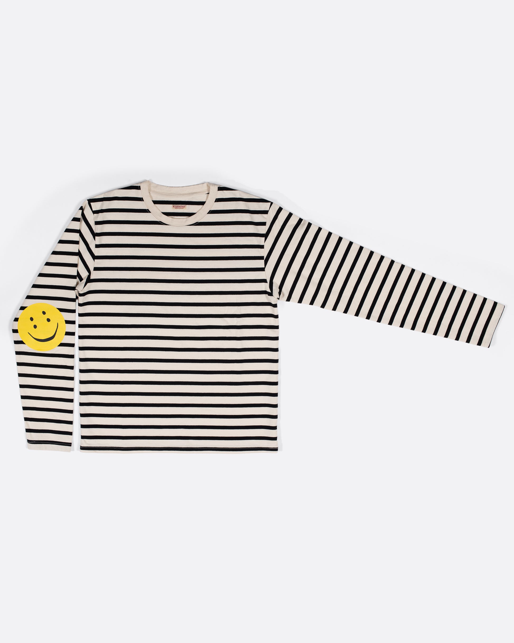 A black and white striped, cotton, crewneck shirt with Kapital's fan favorite rainbow smiley elbow patches.