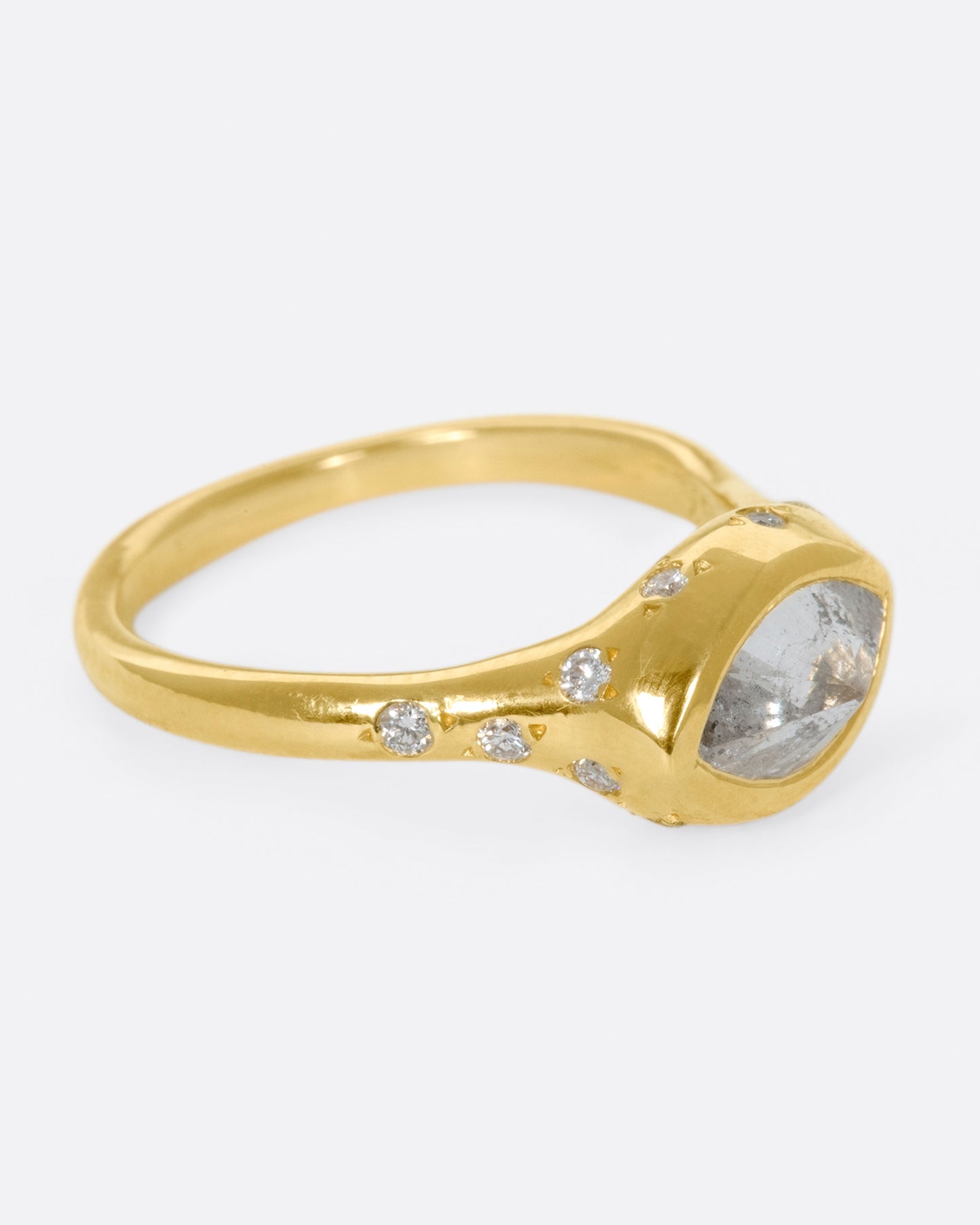 This ring is made extra special by the inverted, east-west diamond at its center.