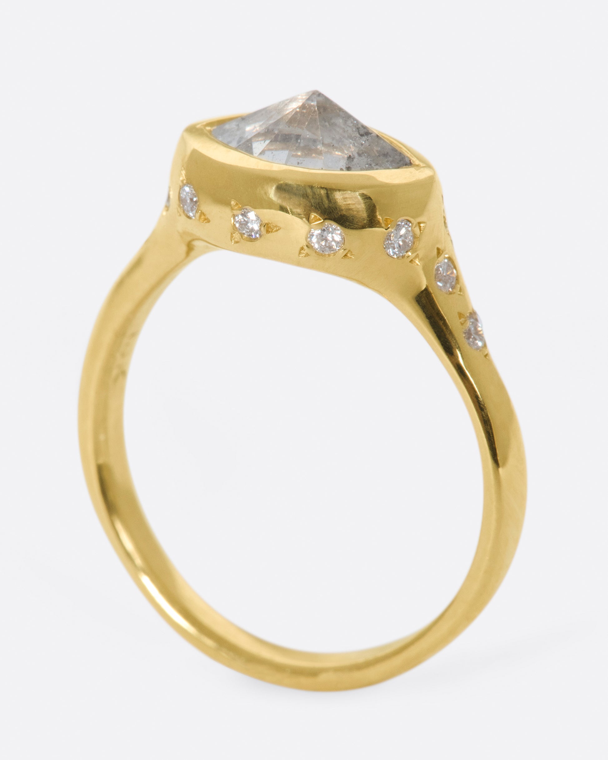 This ring is made extra special by the inverted, east-west diamond at its center.