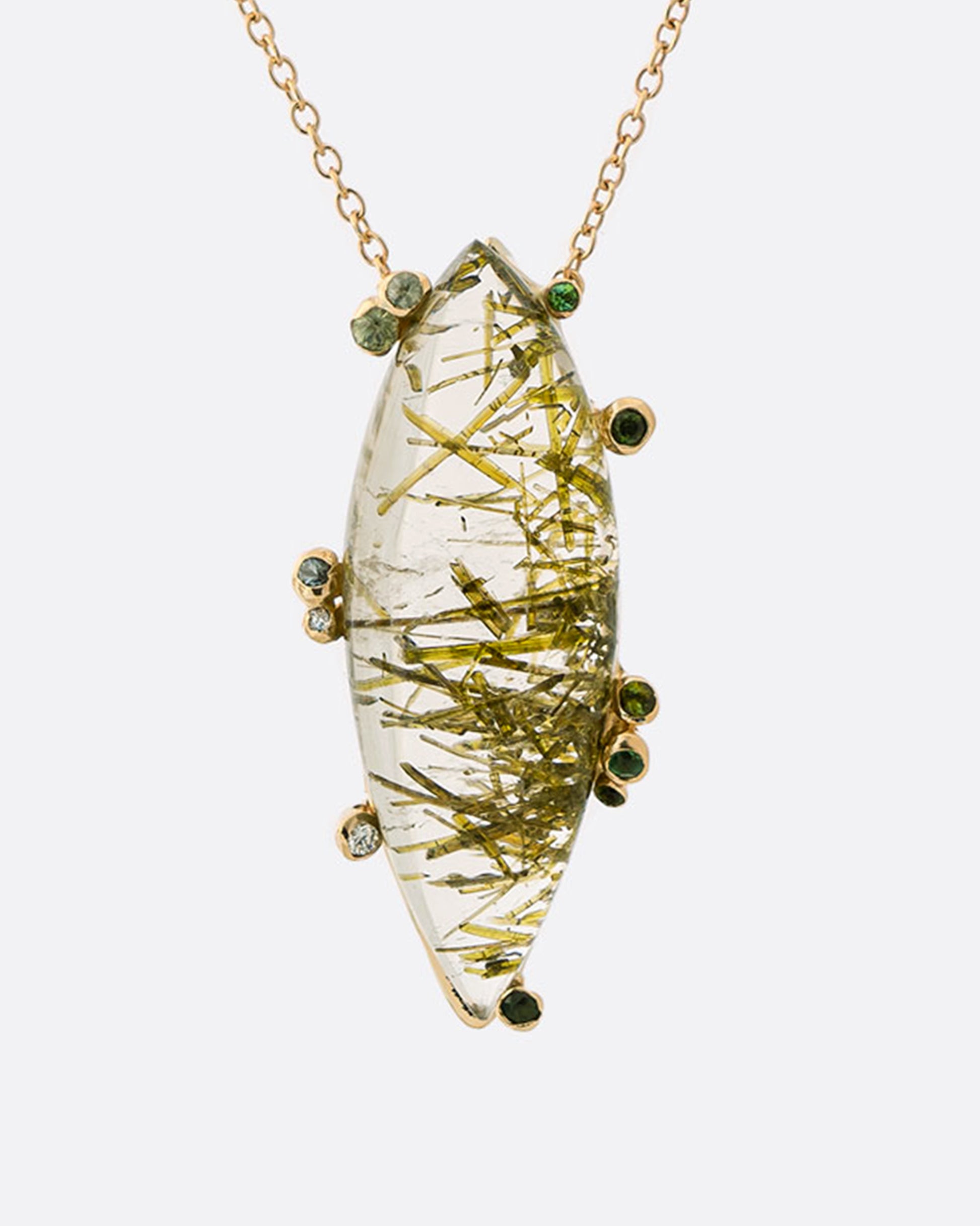 This quartz pendant has a garden of green tourmaline needle inclusions grown within