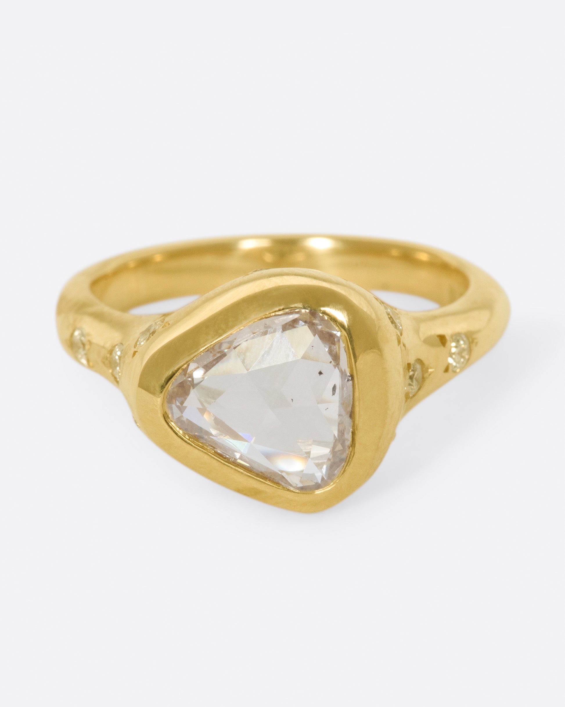 A glorious triangular, rose cut diamond sits on its side giving this ring an east-west sensibility.