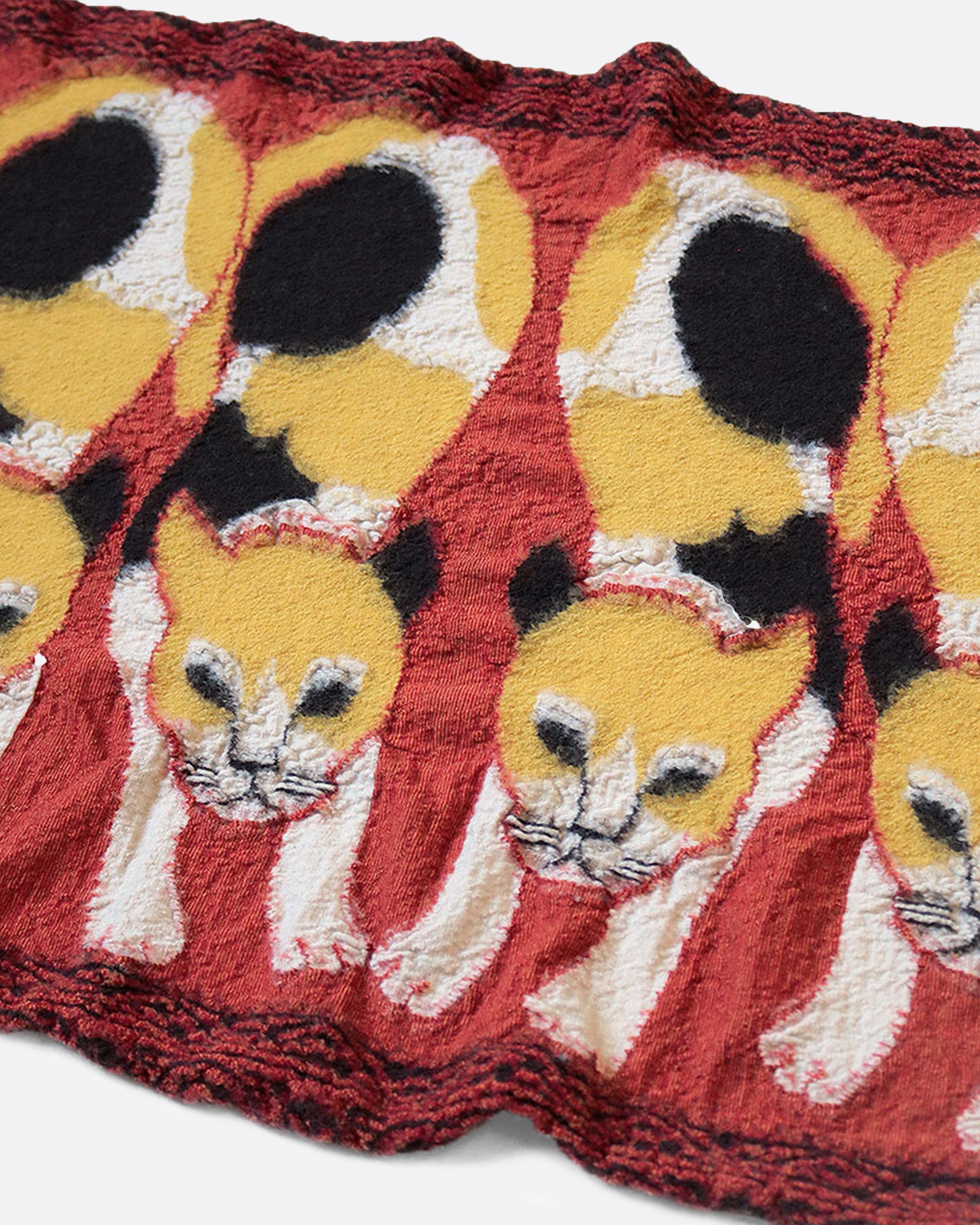 A fluffy wool scarf lined with calico cats.