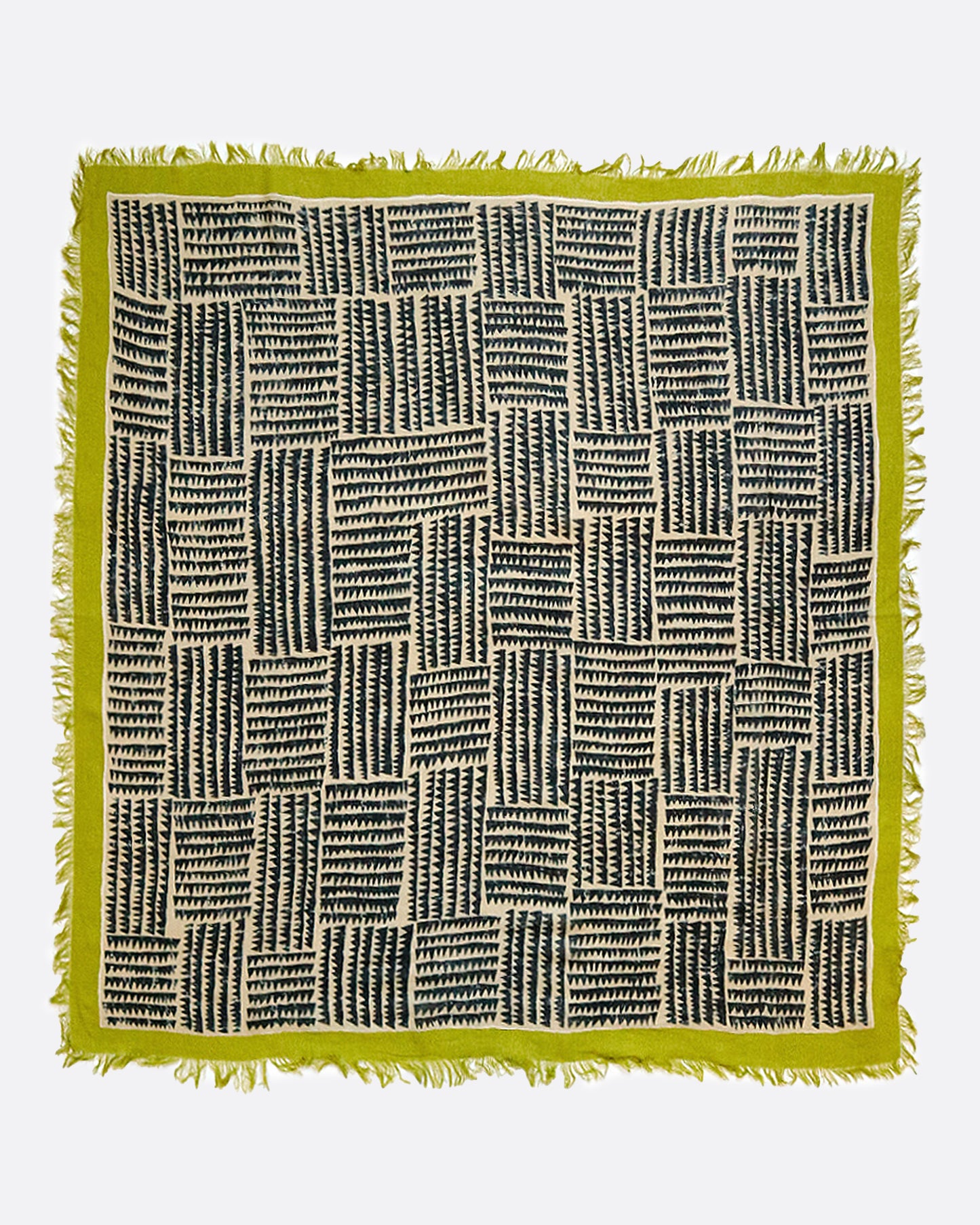A large, fringy stole covered in a sawtooth block pattern with lime green edges.​