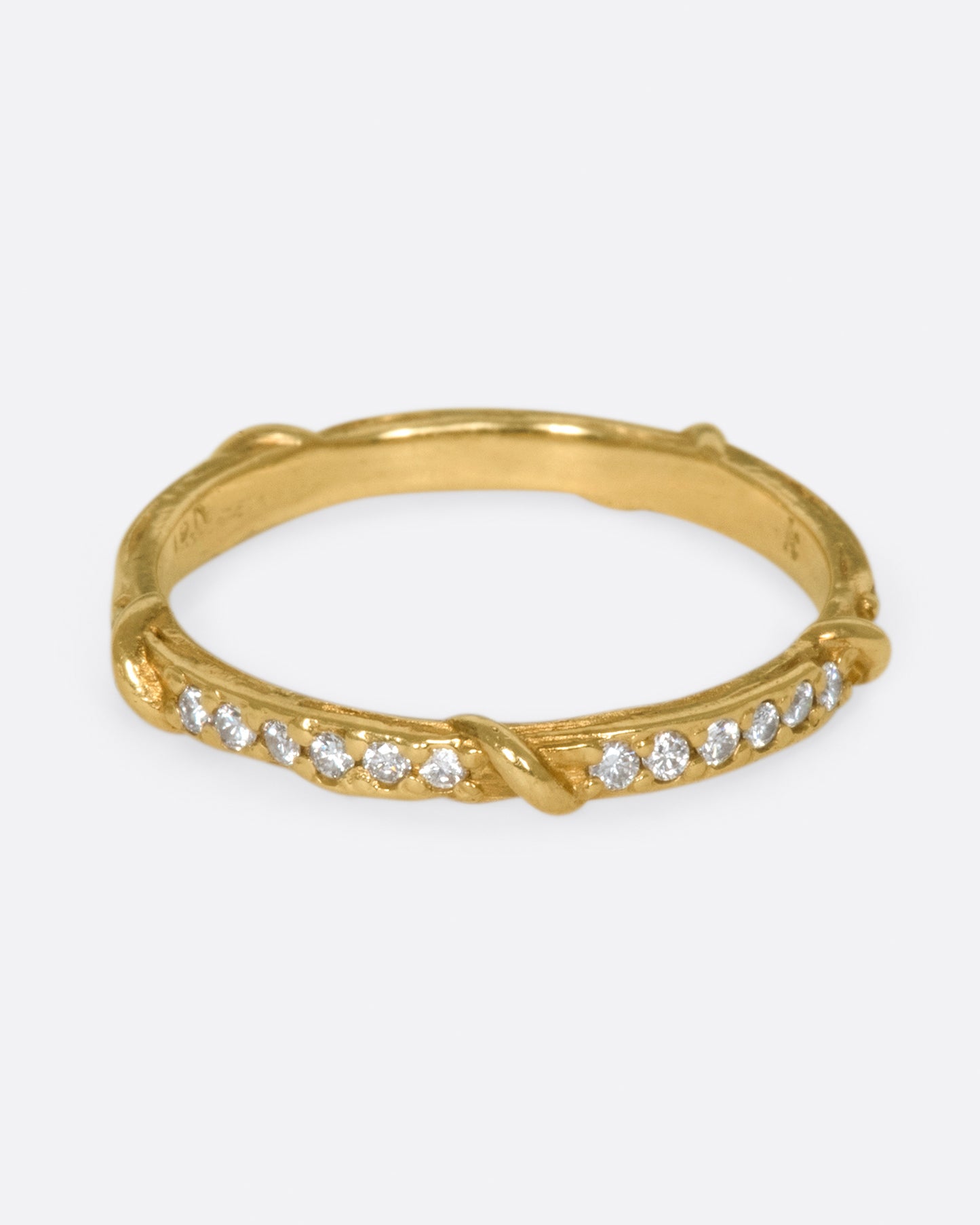 Studded halfway around with diamonds, this band is a twist on a classic with an organic edge.