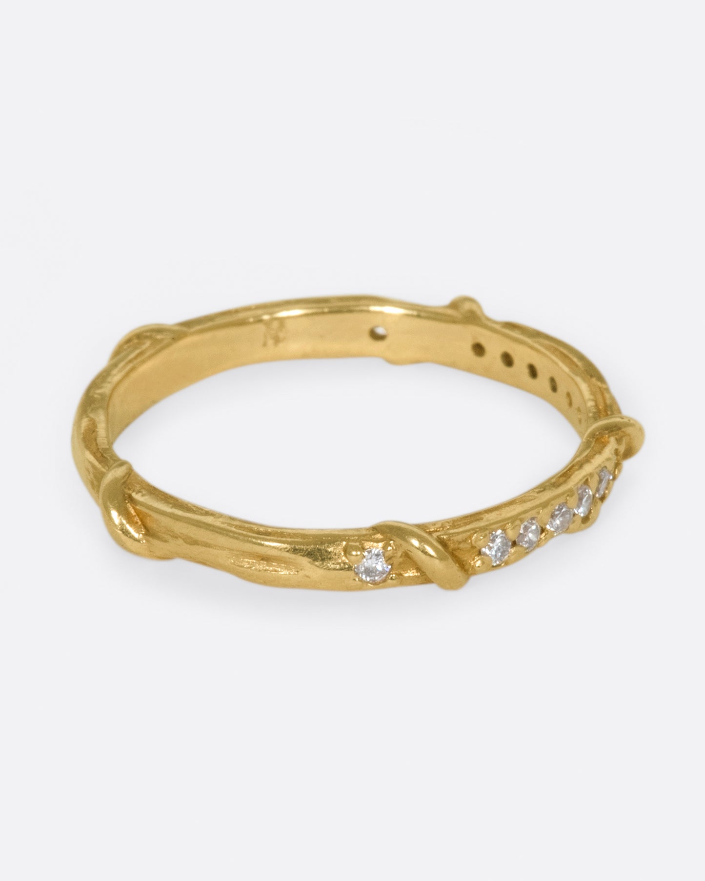 Studded halfway around with diamonds, this band is a twist on a classic with an organic edge.