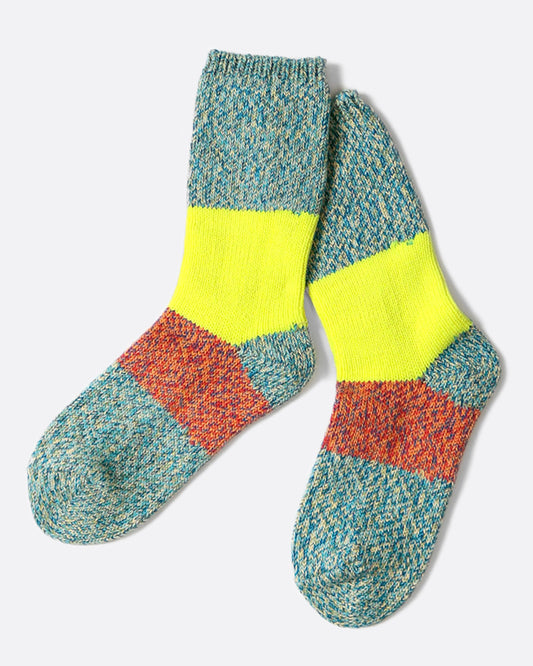 These thick turquoise blue socks are rich and fluffy with wide neon yellow and orange stripes down the center.
