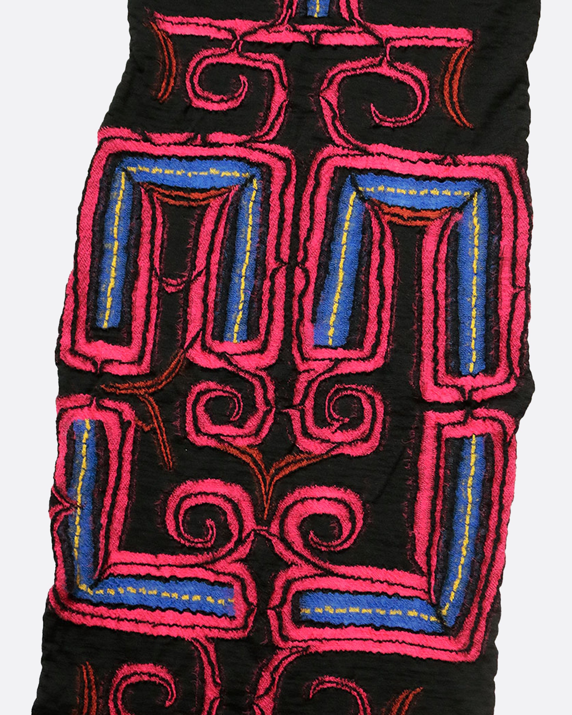 A black scarf with a neon pink Ainu pattern