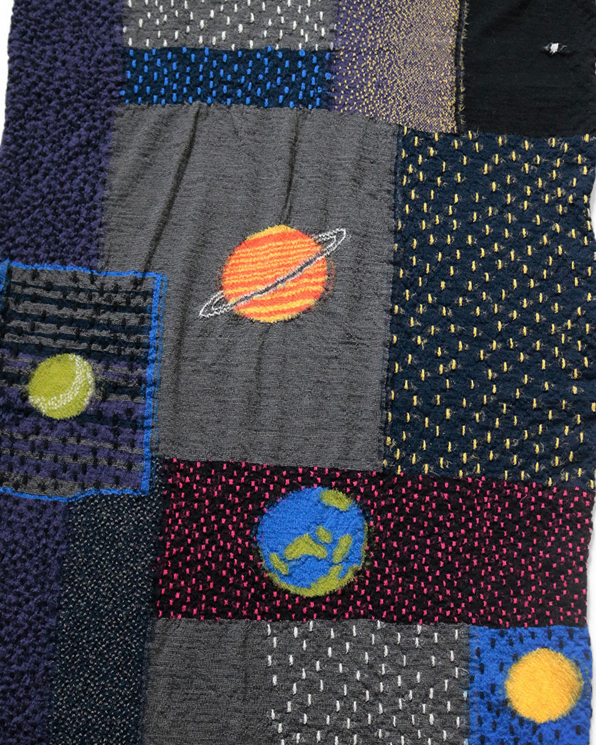 A Gabbeh style wool scarf with warm, sunlit planets.