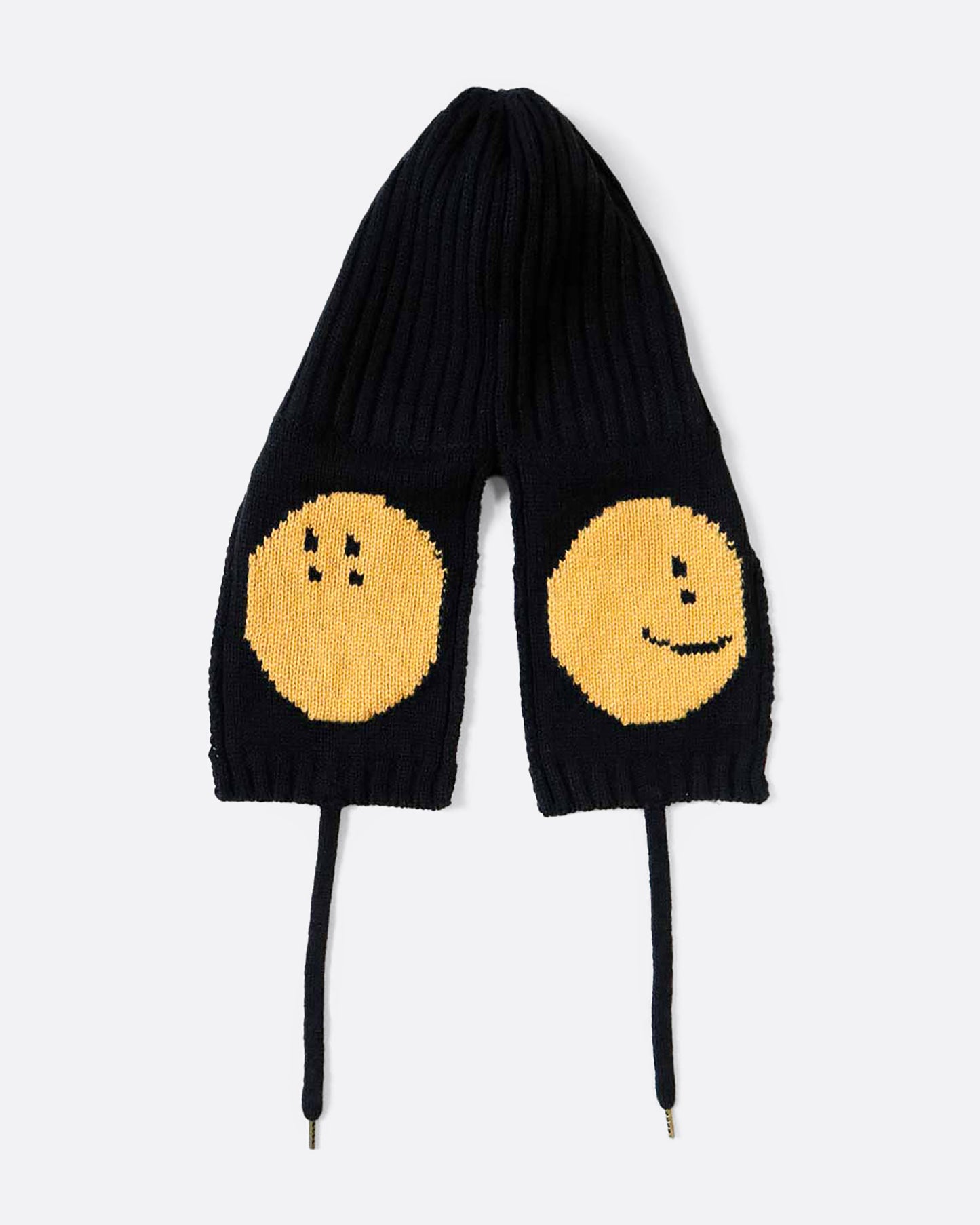 A black knit hat with yellow smilie faces on either ear flap. View from the back, laying flat.