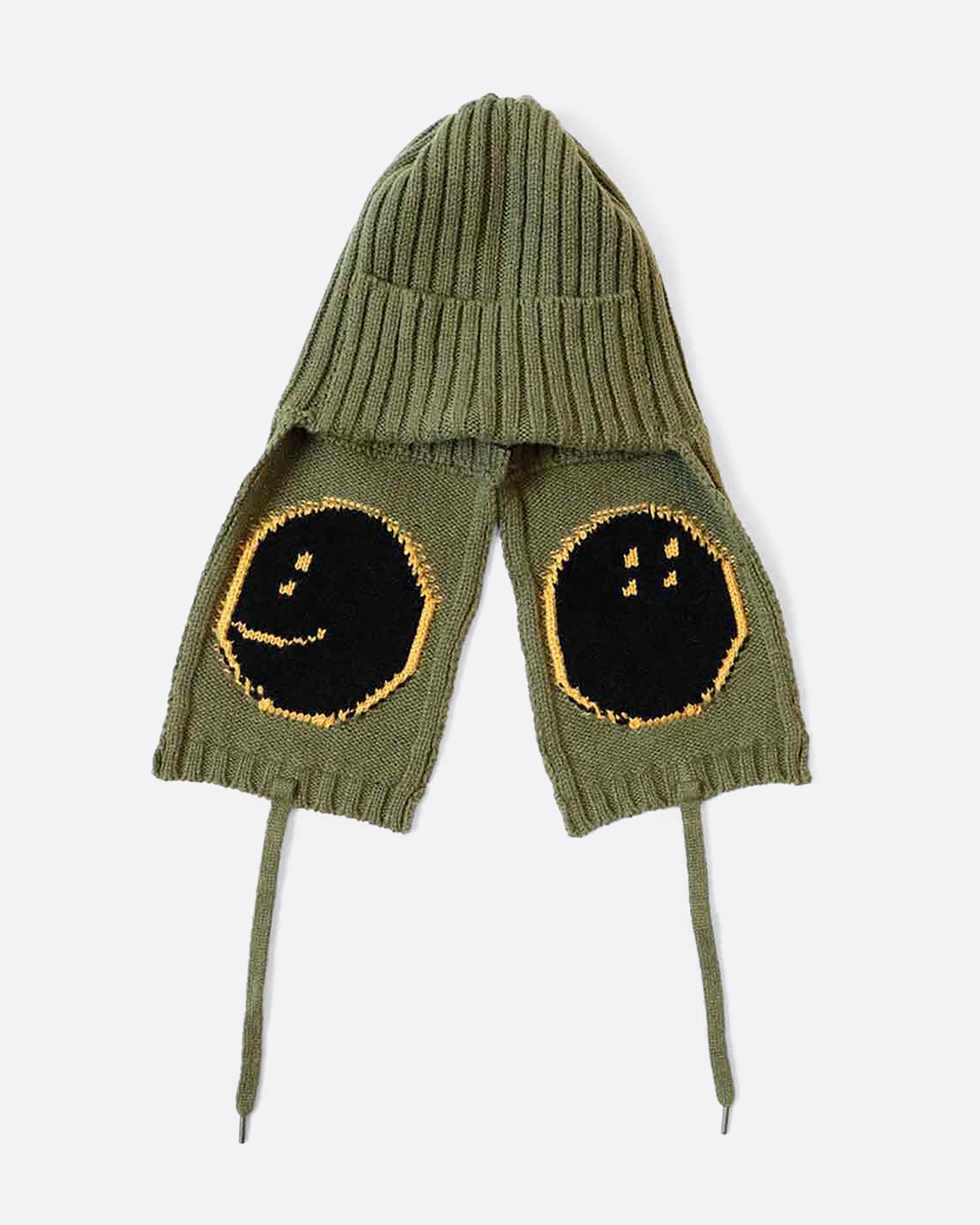 A khaki green hat with yellow smilie faces on either ear flap. View from the back, laying flat.