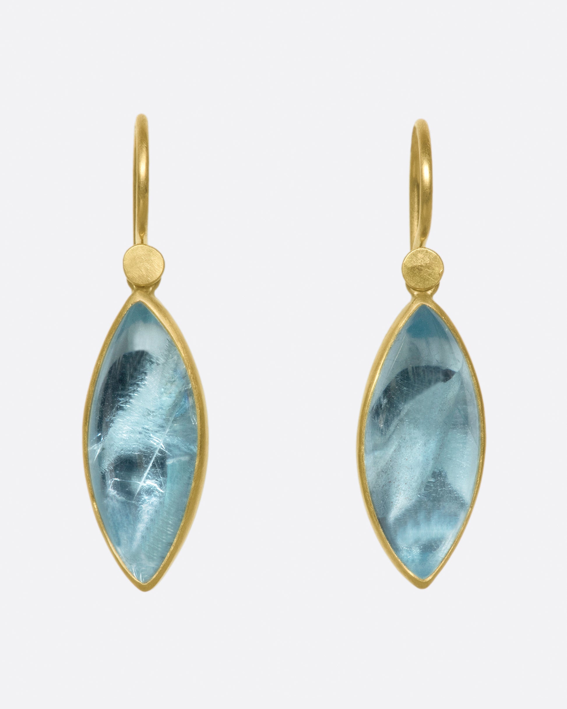 A pair of 18k gold dangling earrings with aquamarine navette drops.