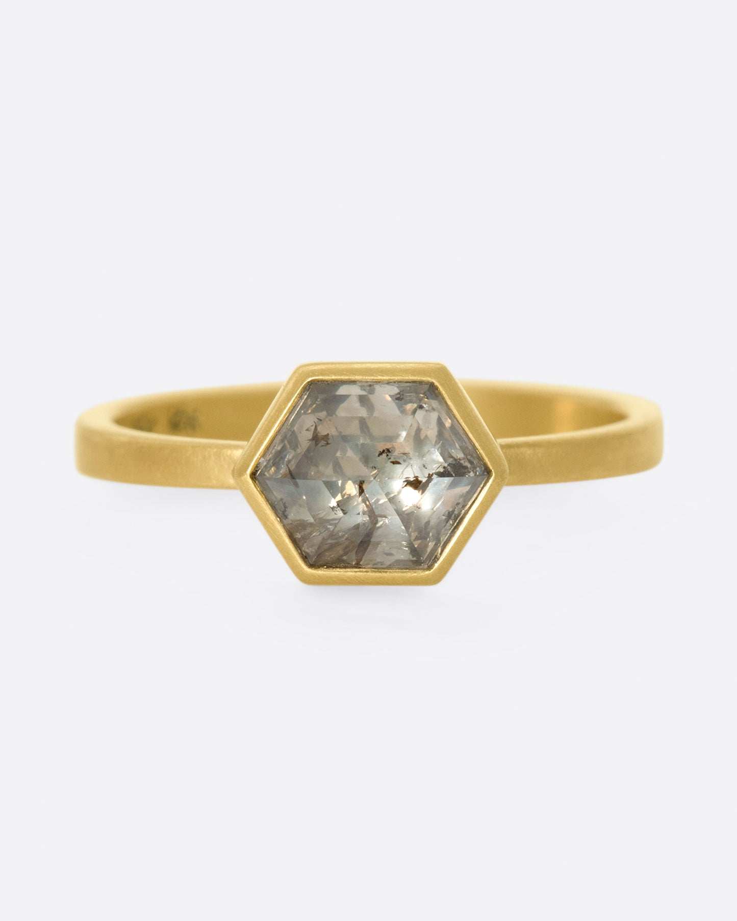 A hexagonal, faceted diamond whose colors range from shades of brown to gray